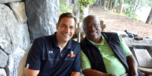 An image of Justice Clarence Thomas and author/attorney Mark Paoletta. 