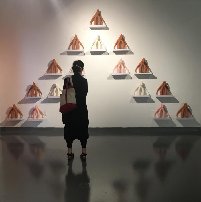 Viewer in front of Swan series. “Cliteracy: The Art of Intimate Justice” is on exhibition at the CVPA Campus Gallery, UMass Dartmouth, 285 Old Westport Road, North Dartmouth, through Nov. 4.