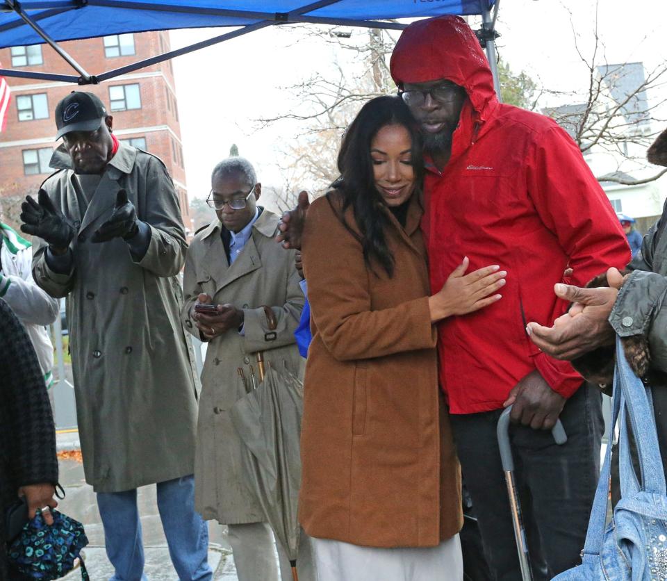 Portsmouth Assistant Mayor Joanna Kelley embraces her friend Mamadou Dembele after she spoke during a protest held at the African Burying Ground Memorial Park in Portsmouth Sunday, Dec. 3, 2023. Dembele alleges he was the victim of a racist attack in Portsmouth.